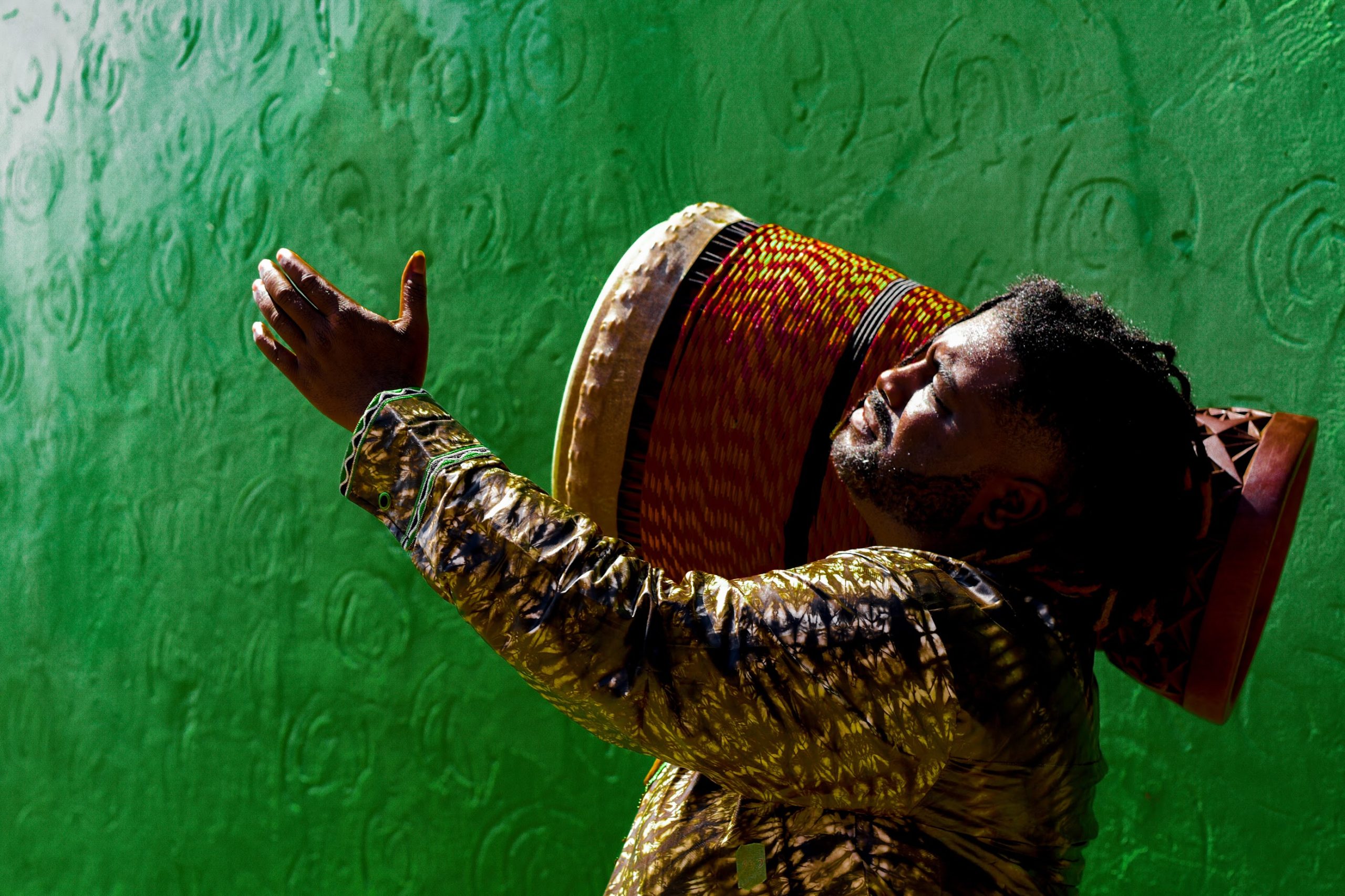 An image of Weedie Braimah with a djembe